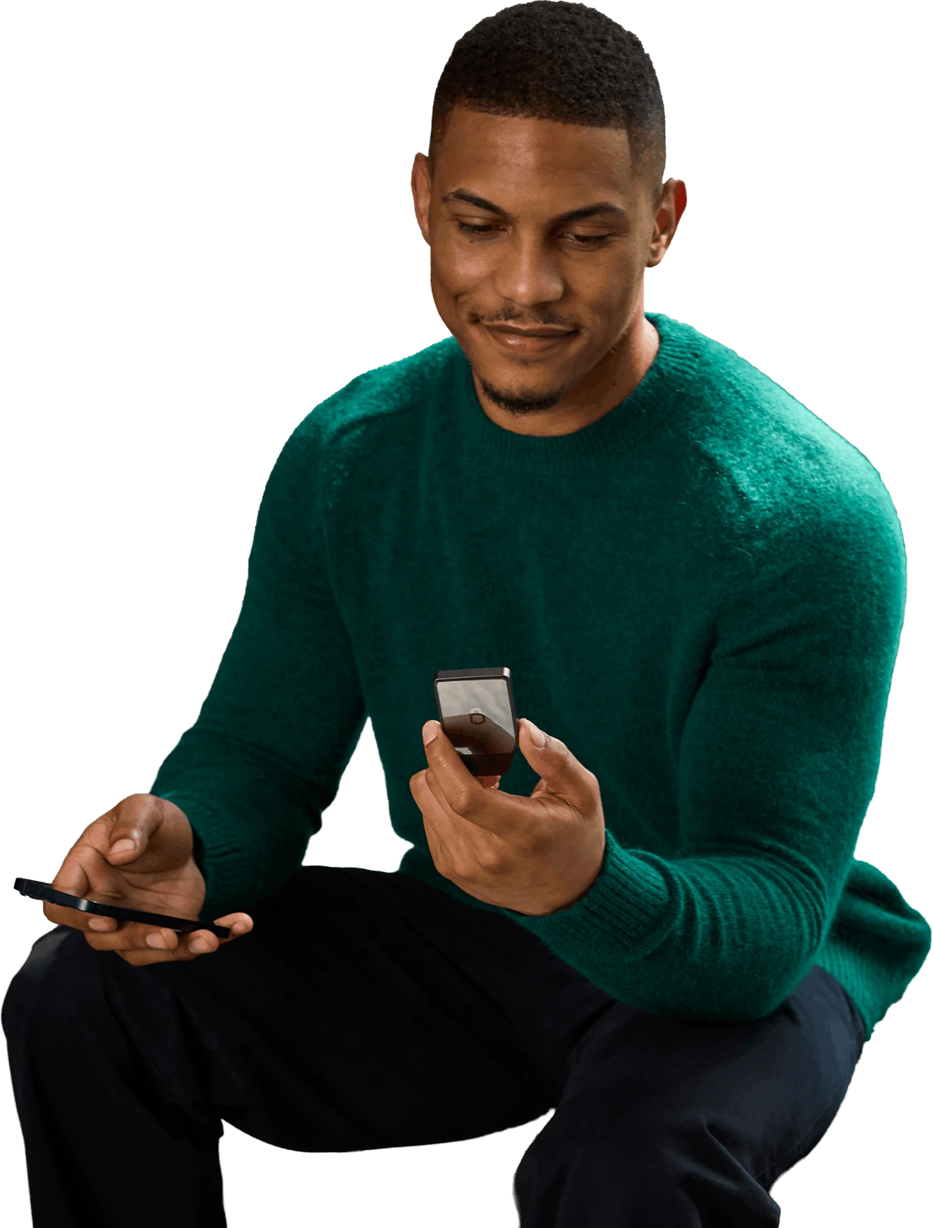 Man in a green sweater holding a Trezor Safe 7 hardware wallet